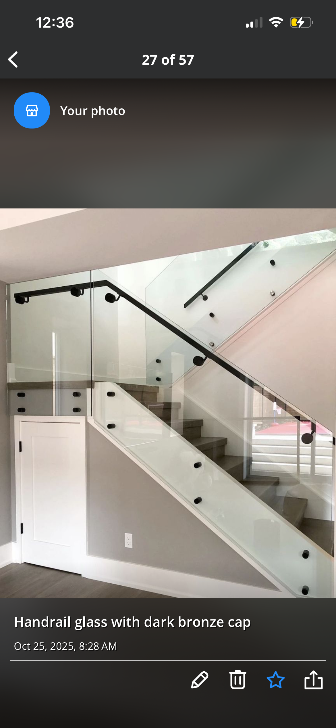 Glass handrail installation with dark bronze cap on staircase