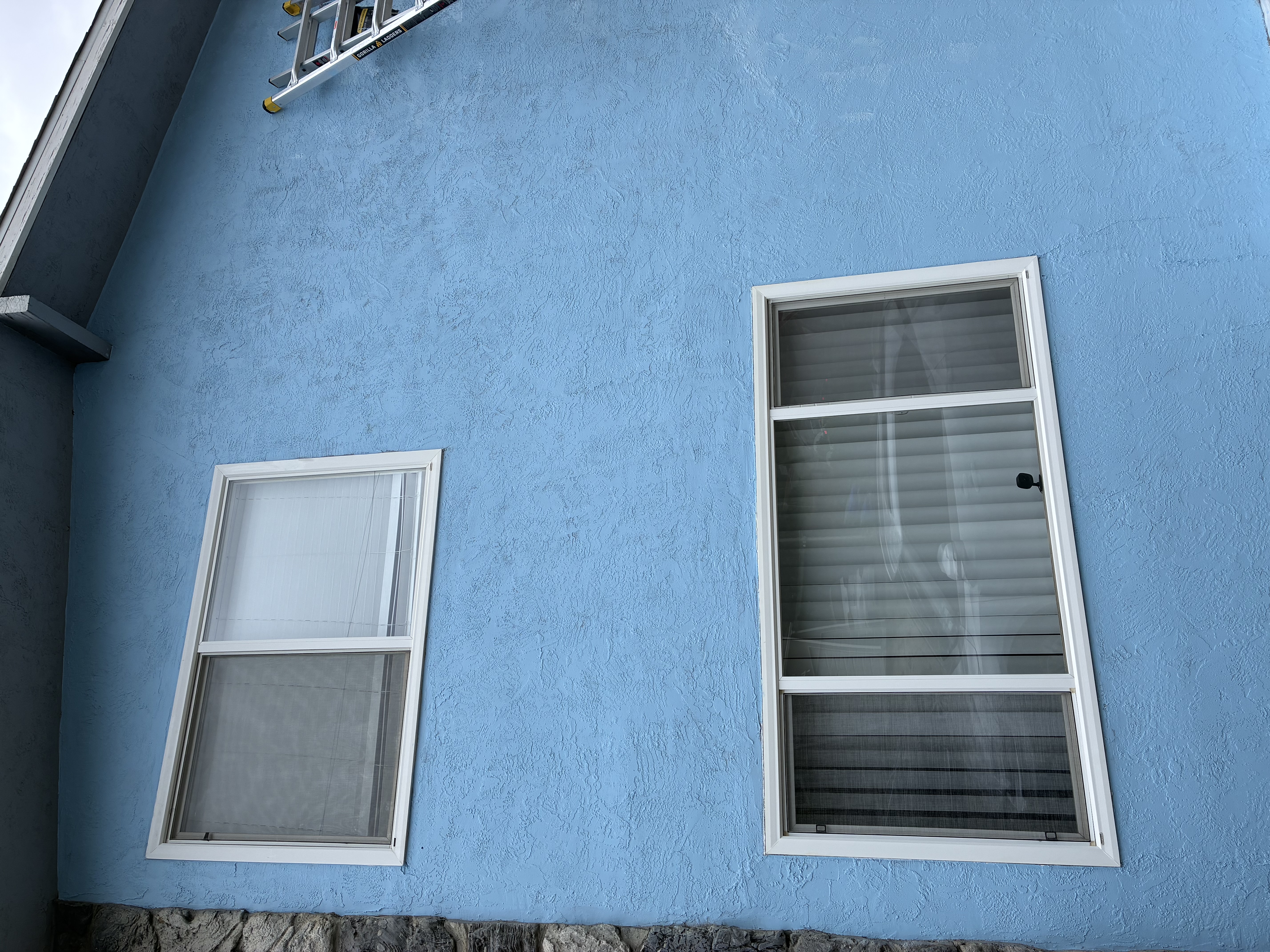 Exterior house painting - fresh blue stucco finish